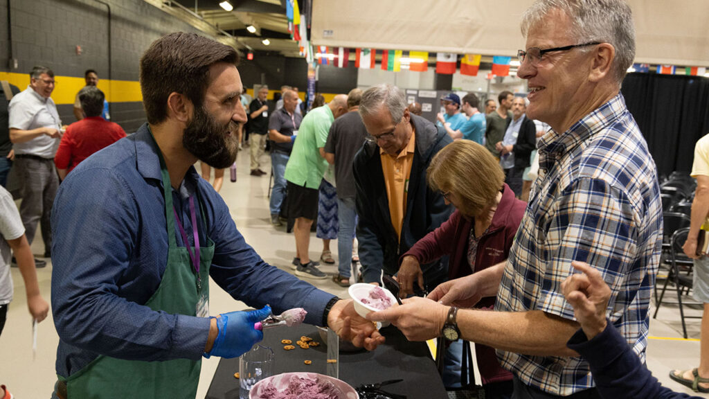 Bishop Nathan Good serves ice cream after one of the plenary sessions. — Jonathan Charles for AW