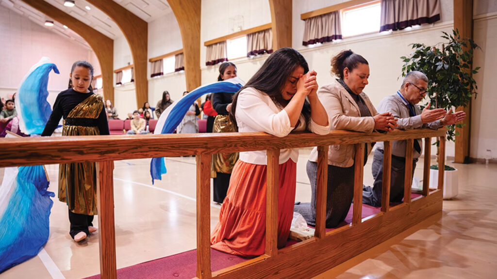 Worshipers pray at Ríos de Agua Viva (Rivers of Living Water) in Shippensburg, Pa., one of a growing number of Spanish-speaking Brethren in Christ congregations. — Brethren in Christ Church