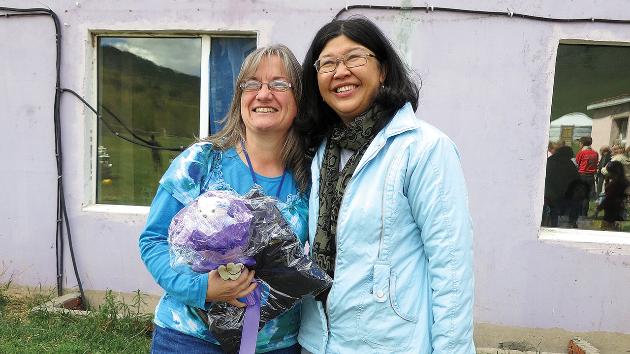 In 2013, Laura Schlabach, left, received a gift from executive director Kwai Lin to mark her 20th year of ministry with JCS International. — John Lapp/MMN