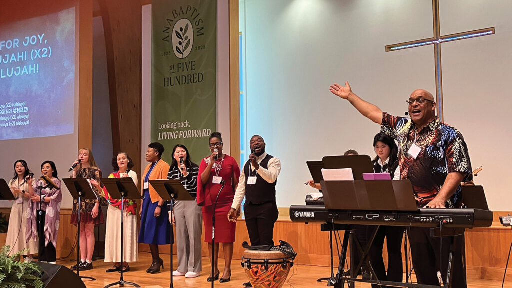 Makinto, right, of Faith Chapel in Los Angeles, and singers from other congregations lead worship at the Mosaic Mennonite Conference assembly in November 2025 in Souderton, Pa. — Paul Schrag/AW