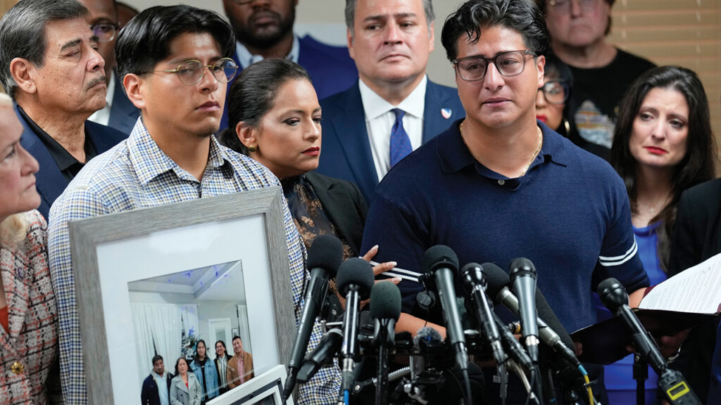 Lorenzo Salgado Jr., son of Lorenzo Salgado Araujo, holds a family photograph during a news conference July 8 in Houston. — David J. Phillip/AP