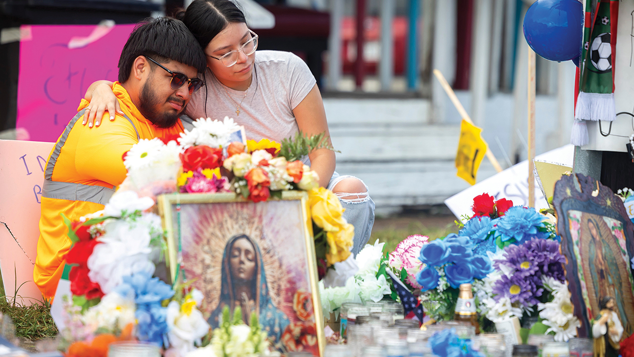 Albert Salgado, left, is comforted by his girlfriend at the site where his uncle Lorenzo Salgado Araujo was shot by an ICE officer in Houston on July 10. — Annie Mulligan/AP
