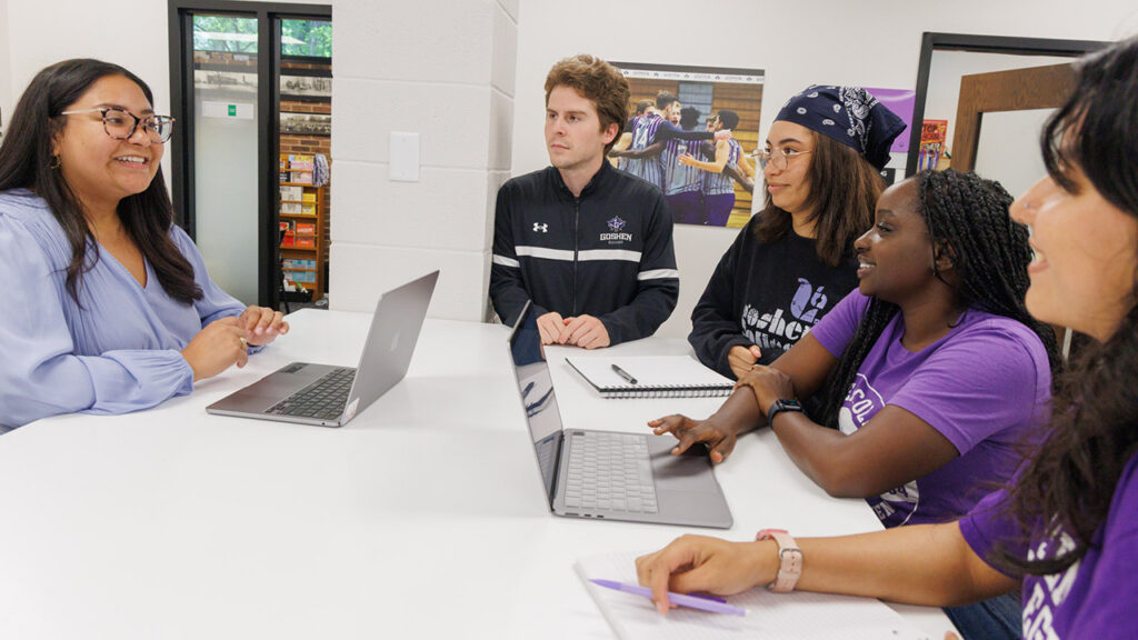 Goshen College academic success coach Isel Herrera works with students Vitor Cassol Zimmerman, Ana Alves Machado, Ziwe Ncube and Mafe Aguilar Vargas in the Academic Success Center. — Goshen College