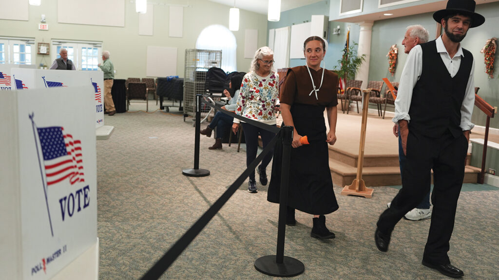 Amish community members Lillian and Samuel Stoltzfus walk out of a polling center after voting in New Holland, Pa., Nov. 5, 2024. — Luis Andres Henao/AP