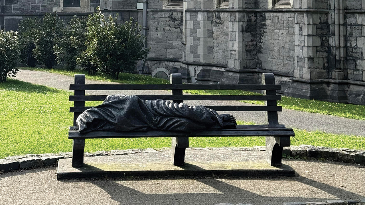 “Homeless Jesus” sculpture on a bench beside Christ Church Cathedral, Dublin, Ireland. — N. Khatsevych/Shutterstock